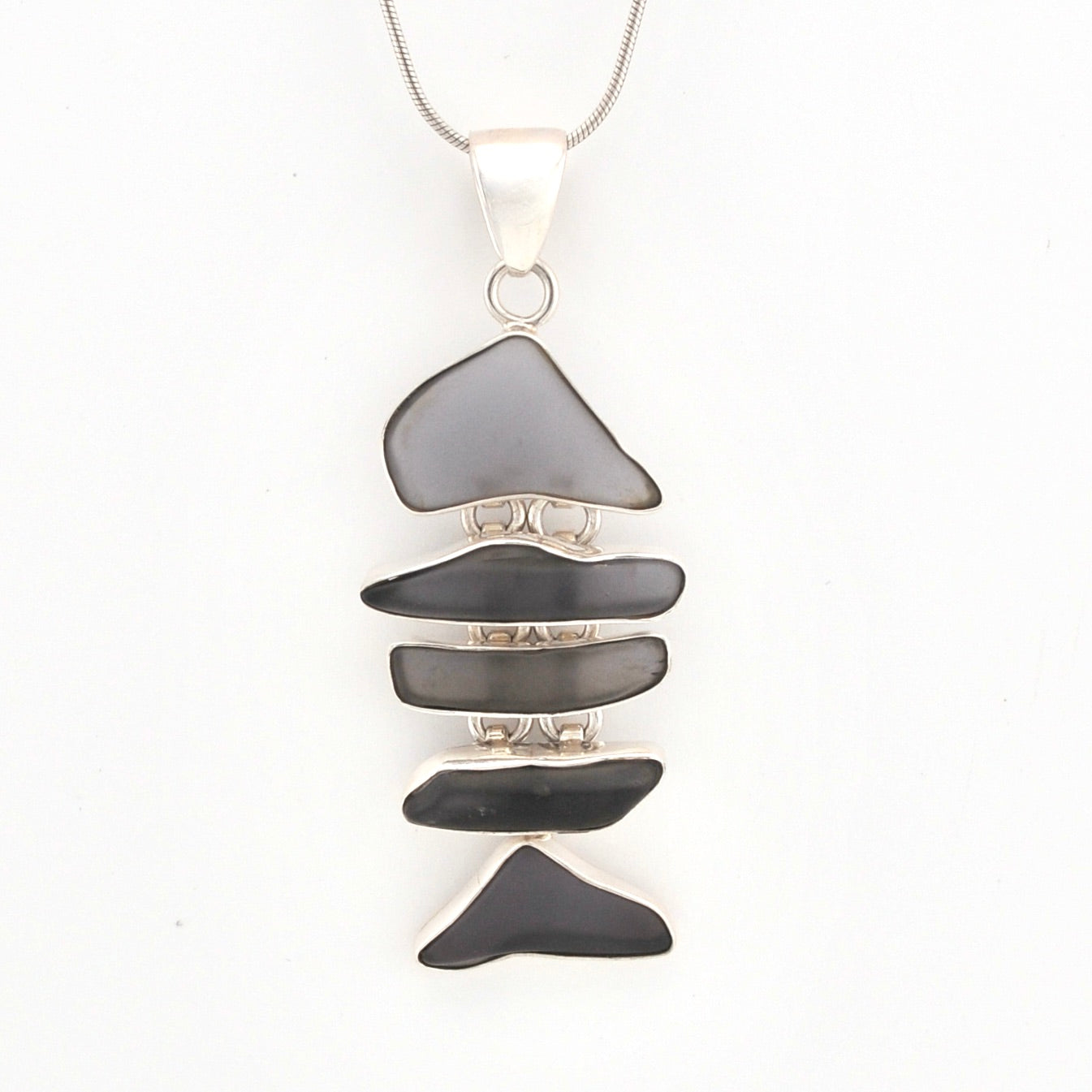 Necklace with a pendant made of stacked violet glass on a white background