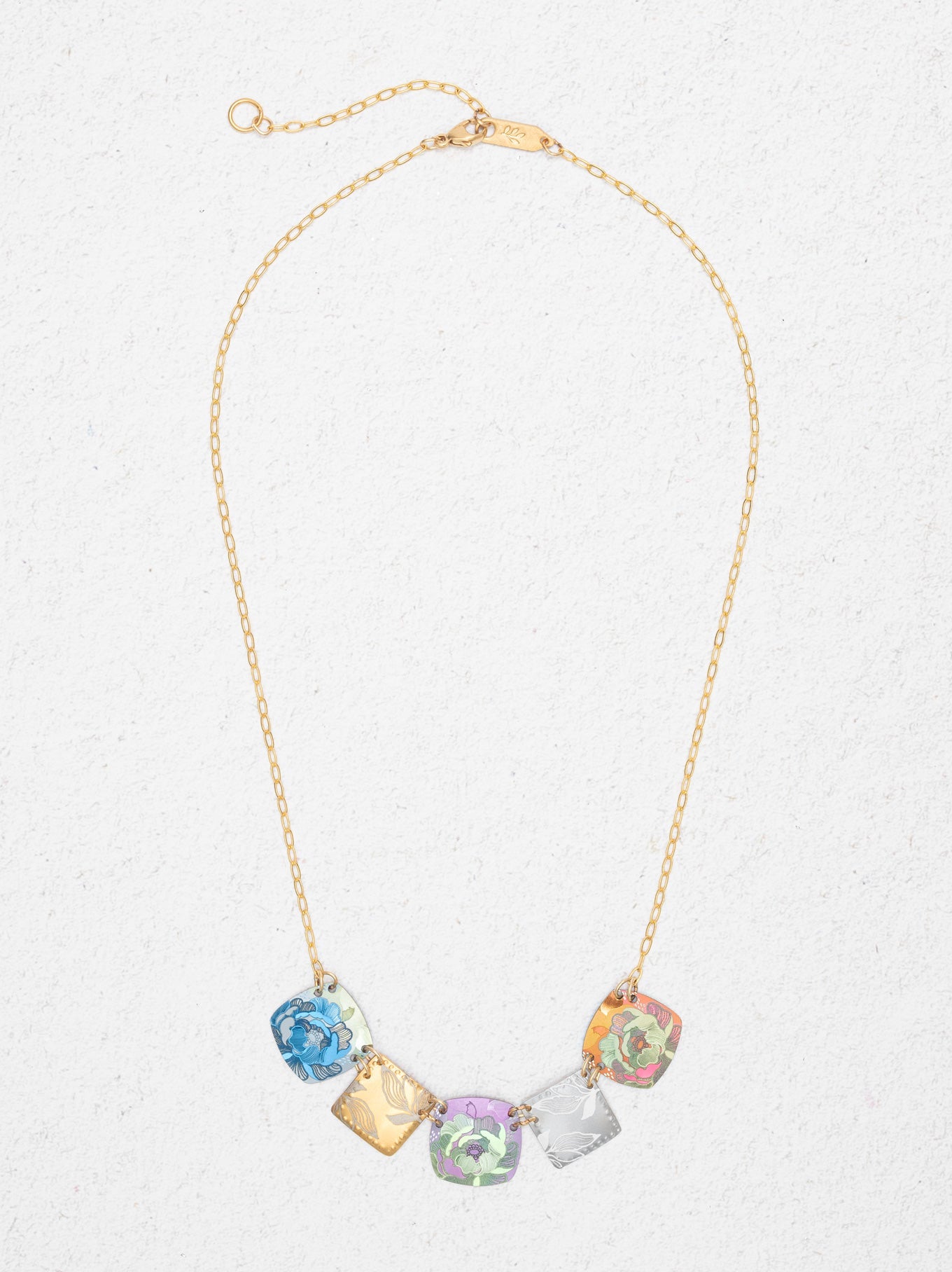 Necklace with colorful crystal pendants on a light gray background