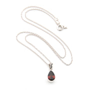Silver necklace with a teardrop-shaped pendant on a white background