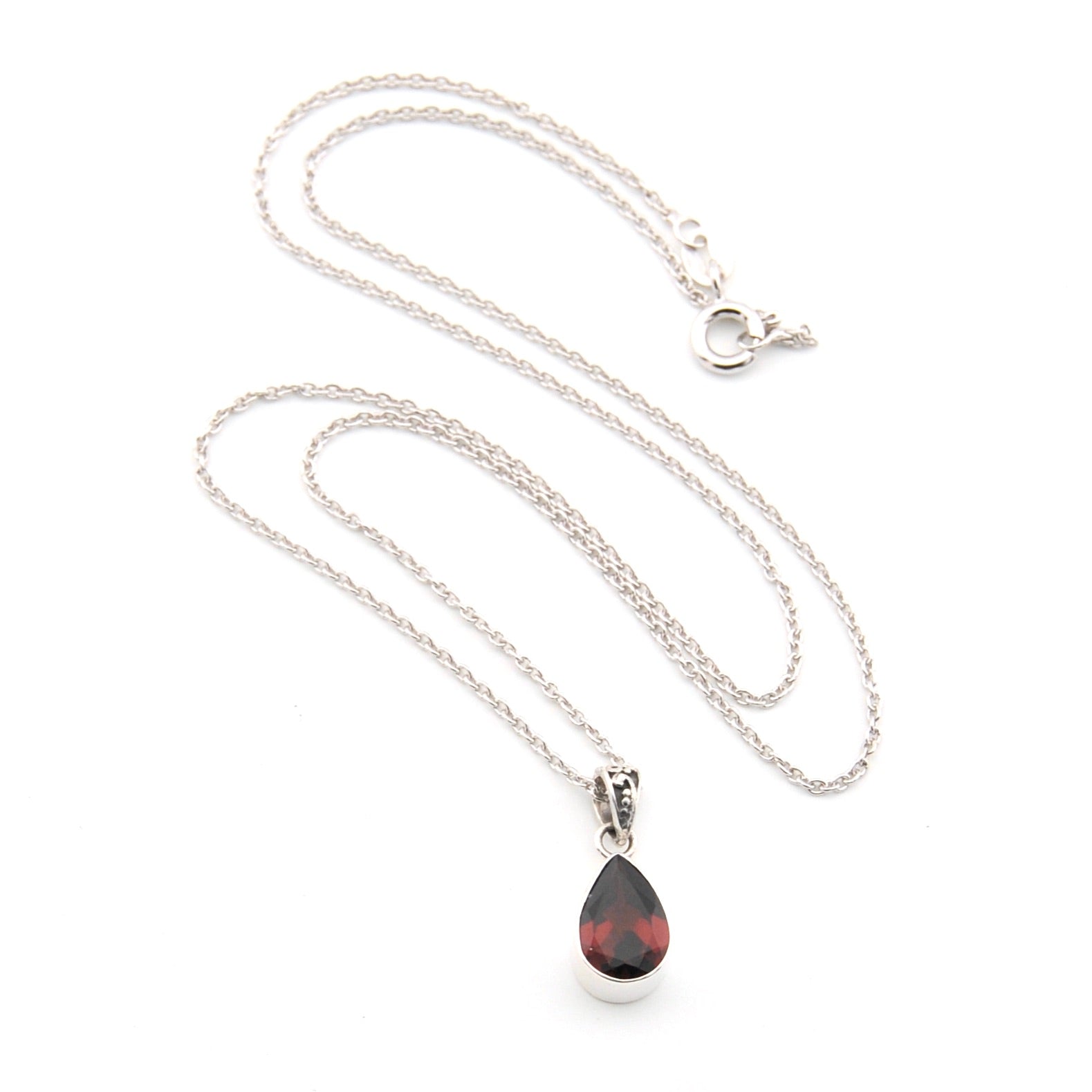 Silver necklace with a teardrop-shaped pendant on a white background