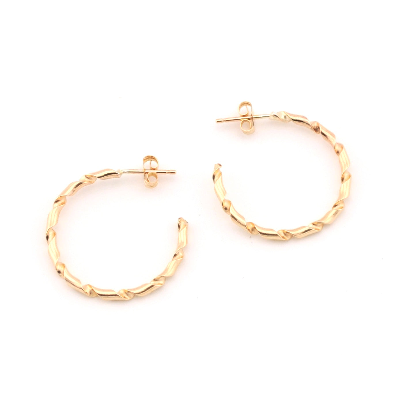 Gold hoop earrings on a white background