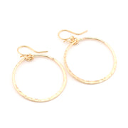 Gold hoop earrings on a white background