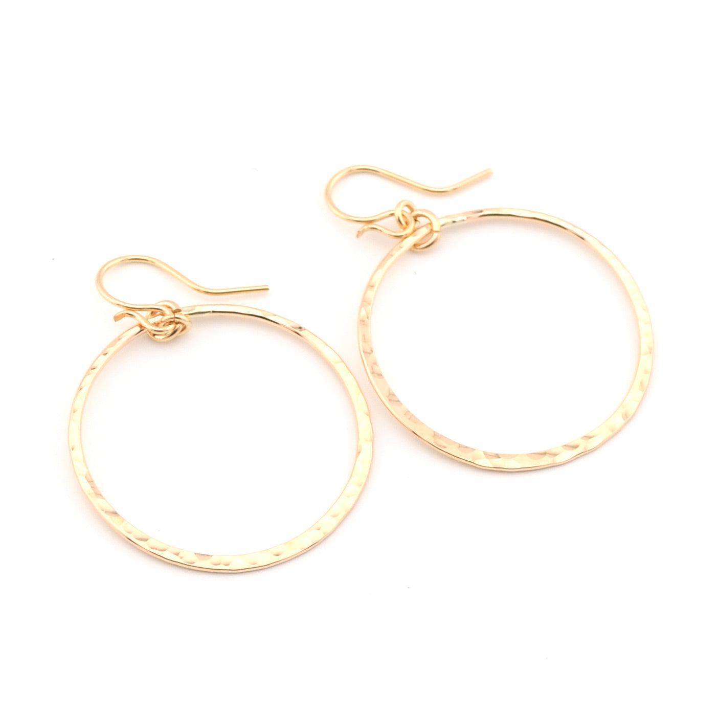 Gold hoop earrings on a white background