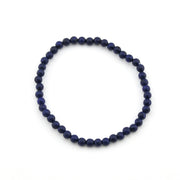 Navy blue beaded bracelet on a white background