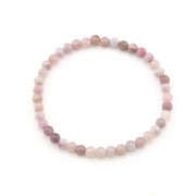 Round beaded bracelet with pink and white stones on a white background