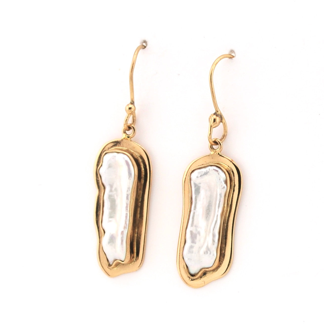 Gold earrings with white pearl-like centers on a white background