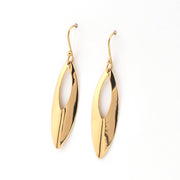 Gold earrings with a white center on a white background