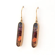 Pair of gold earrings with multicolored oval stones on a white background