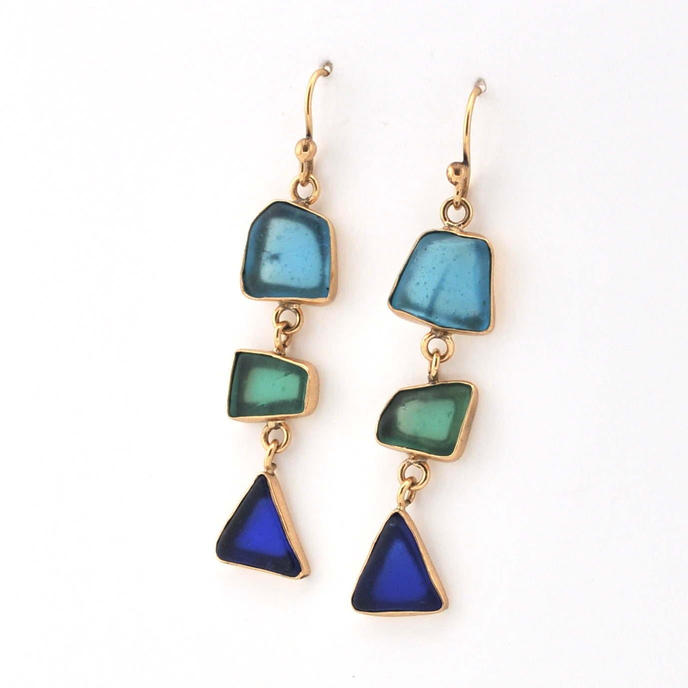 Pair of earrings with blue and green triangular stones on a white background