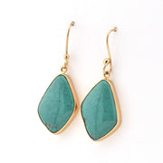 Turquoise earrings with gold hooks on a white background