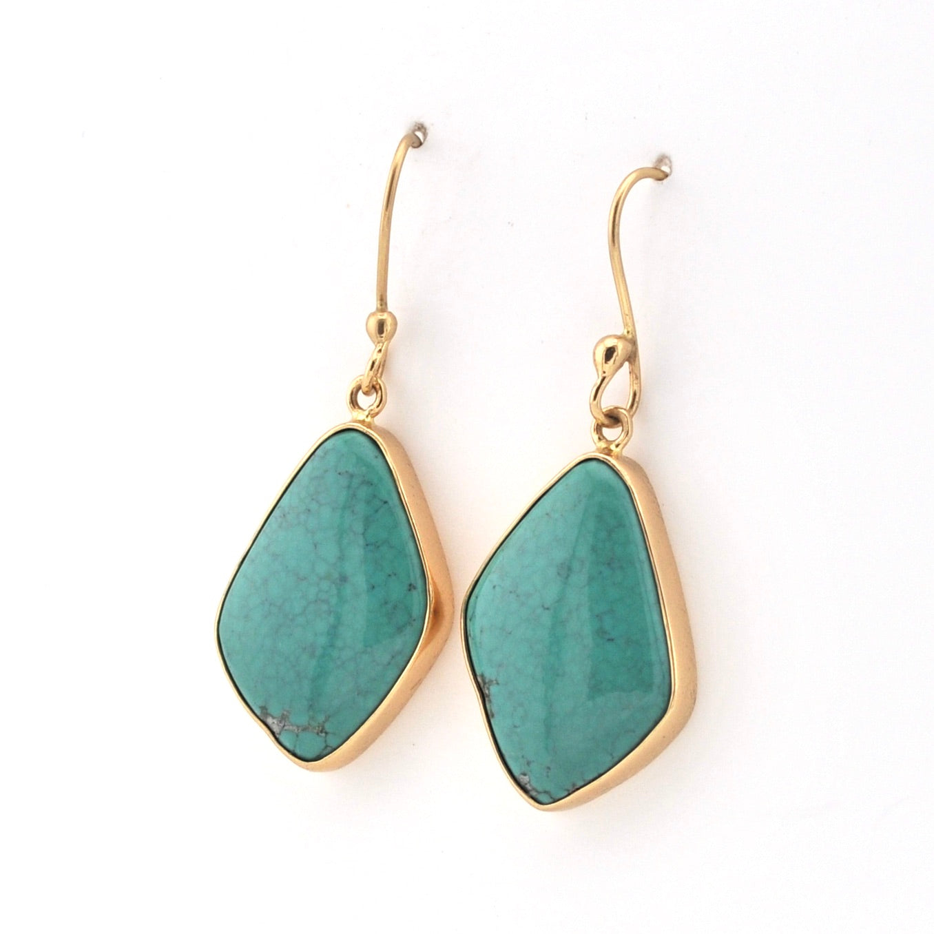 Turquoise earrings with gold hooks on a white background