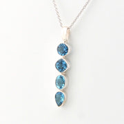 Silver necklace with blue gemstones on a white background