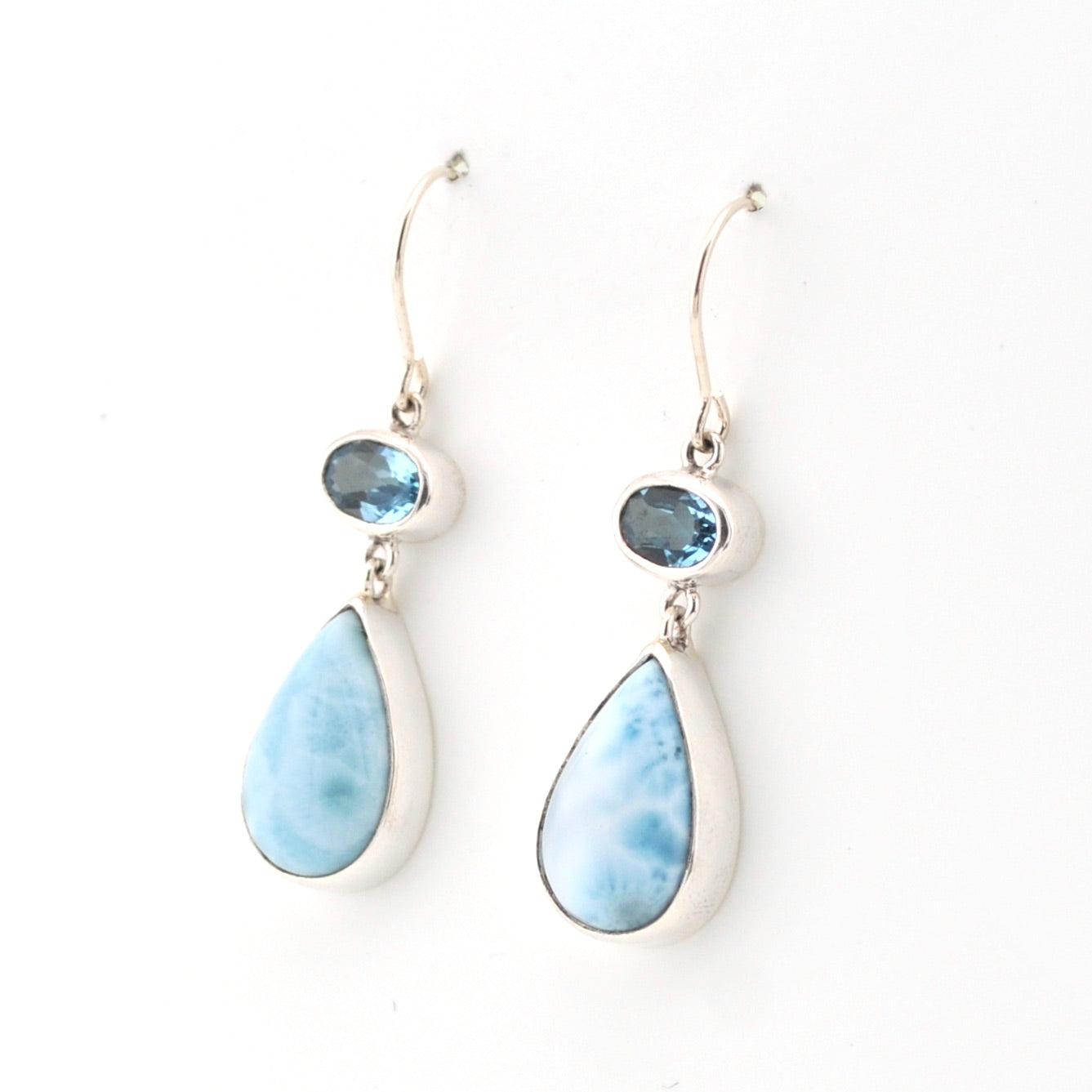 Pair of earrings with blue teardrop-shaped stones on a white background