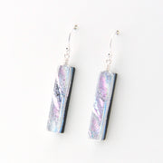 Pair of earrings with iridescent design on a white background