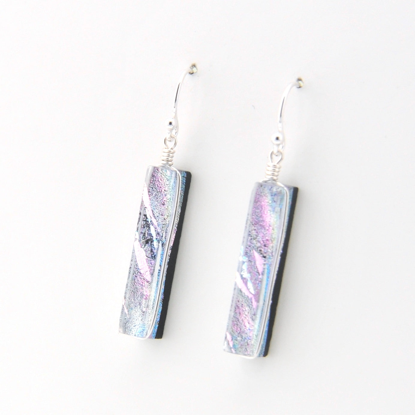 Pair of earrings with iridescent design on a white background