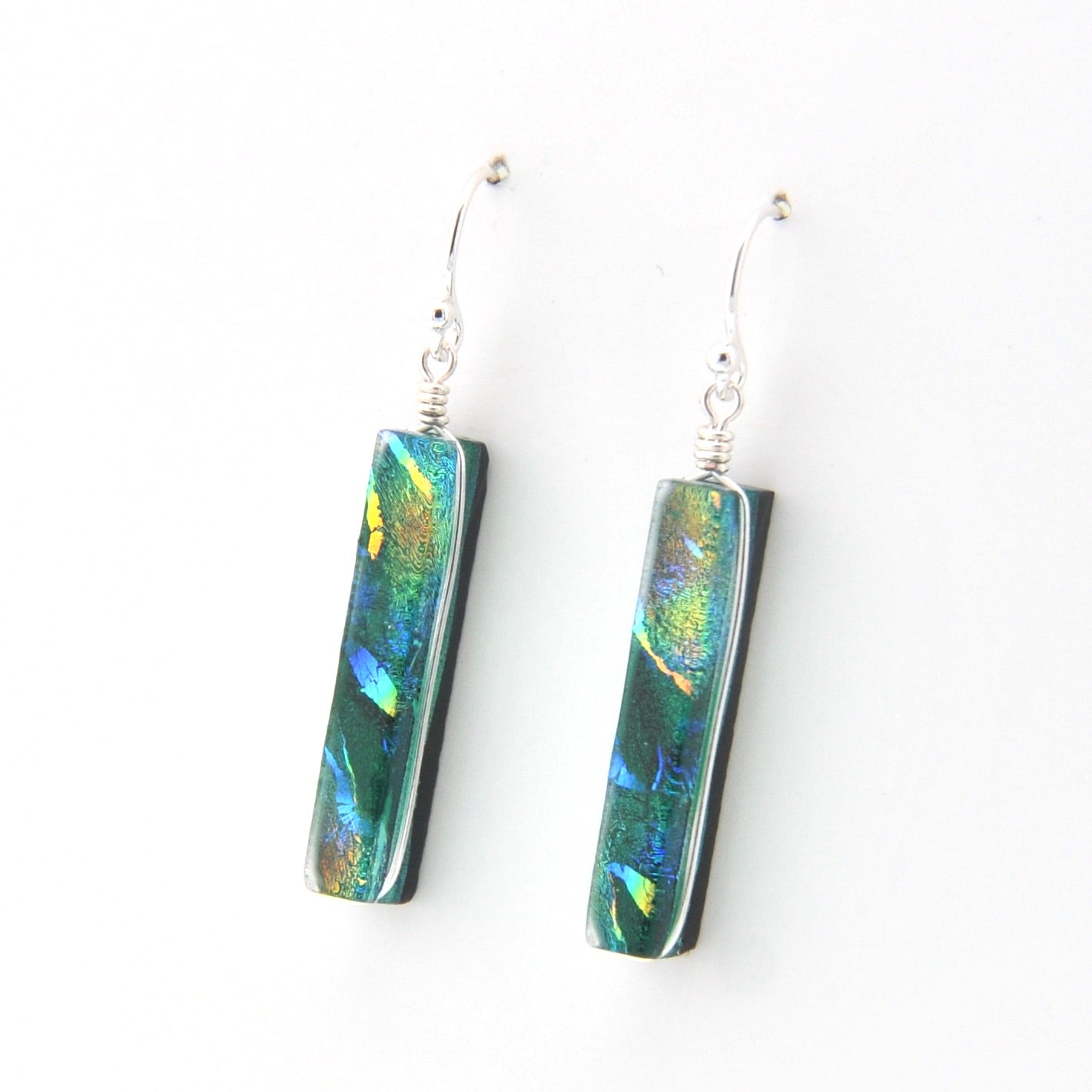Pair of earrings with colorful rectangular stones on a white background
