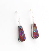 Teardrop-shaped earrings with multicolored iridescent finish on a white background