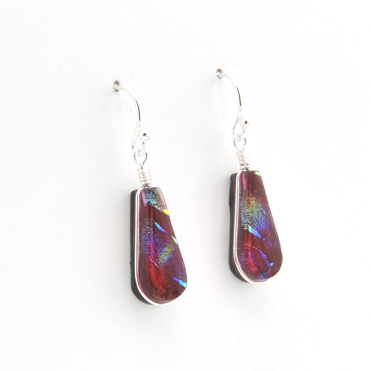 Teardrop-shaped earrings with multicolored iridescent finish on a white background