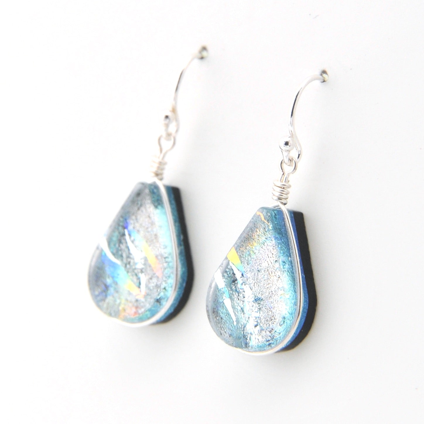 Teardrop-shaped earrings with blue and silver design on a white background
