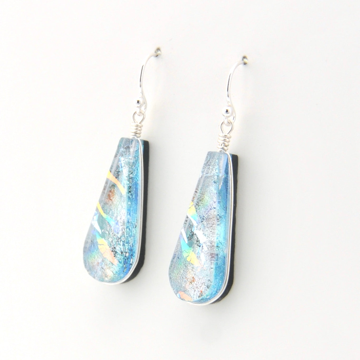 Teardrop-shaped earrings with blue and silver design on a white background