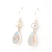 Teardrop-shaped earrings with pearl-like beads on a white background