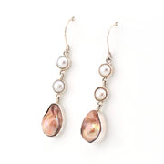 Pair of pearl earrings with teardrop-shaped pearls on a white background