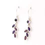 Silver earrings with purple gemstones on a white background