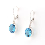 Side View Silver Blue Topaz 8x10mm Oval Dangle Earrings