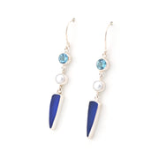 Pair of earrings with blue and white elements on a white background