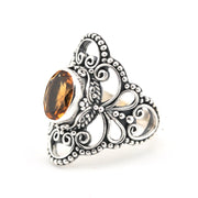 Silver ring with a brown gemstone on a white background