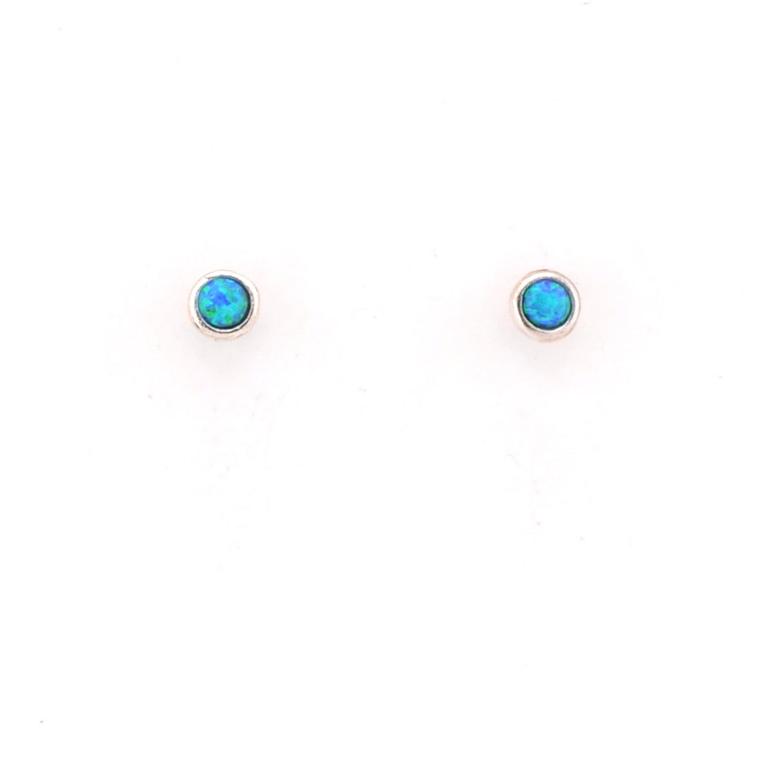 Pair of silver stud earrings with blue gemstones on a white background