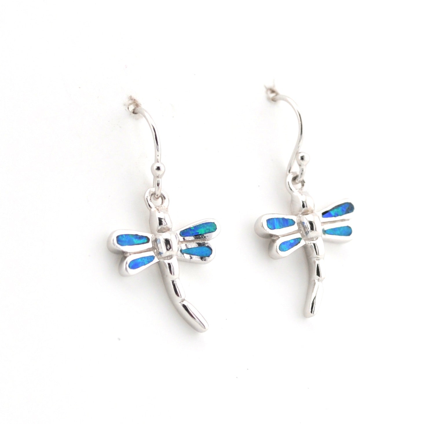 Dragonfly-shaped earrings with blue accents on a white background