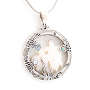 Silver pendant with a shell and small stones on a white background