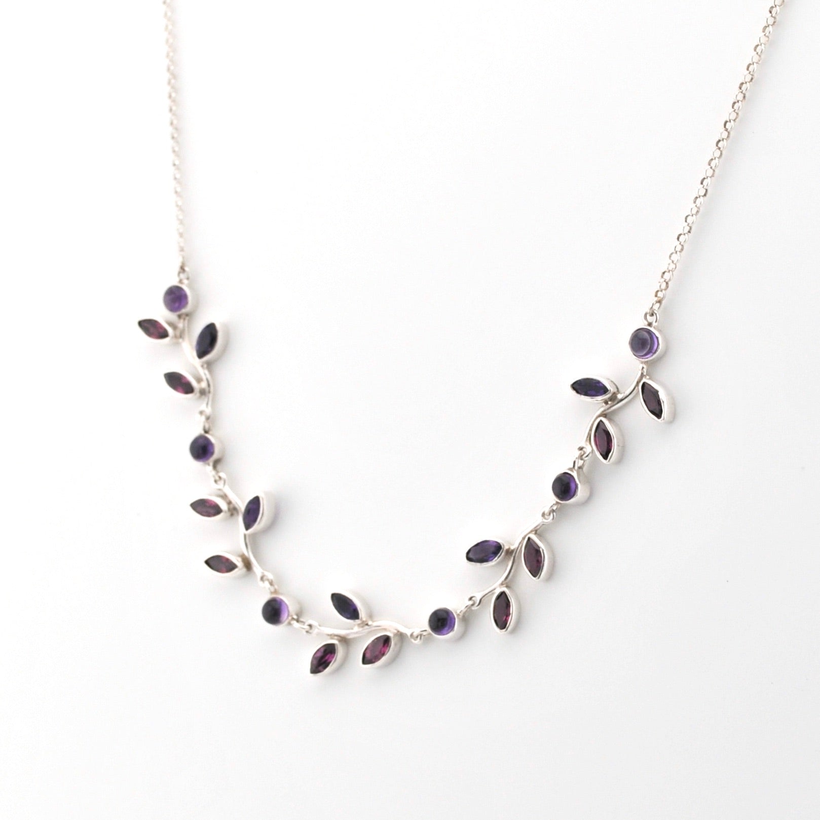 Necklace with purple gemstones on a white background