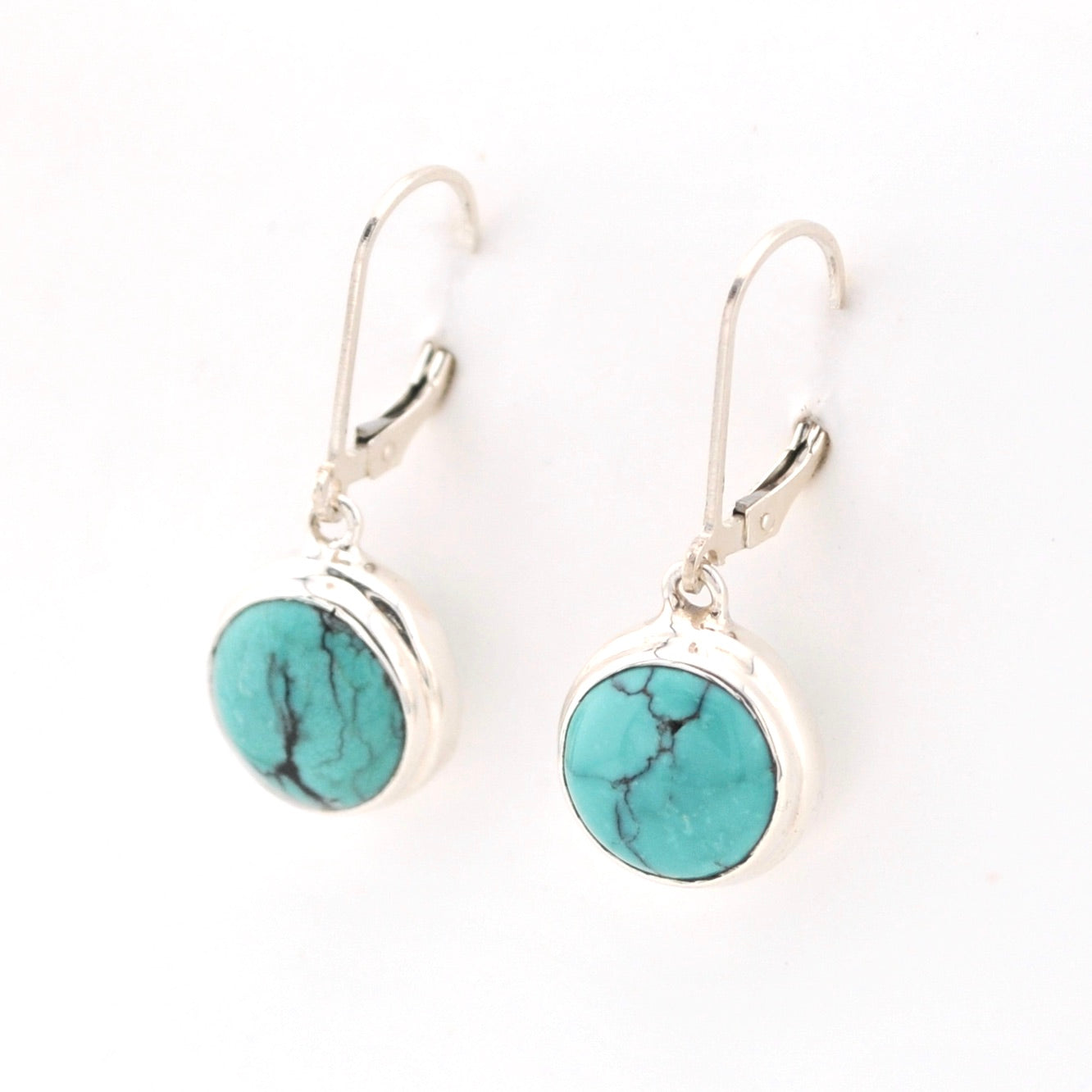 Turquoise stone earrings with silver hooks on a white background