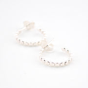 Silver hoop earrings on a white background