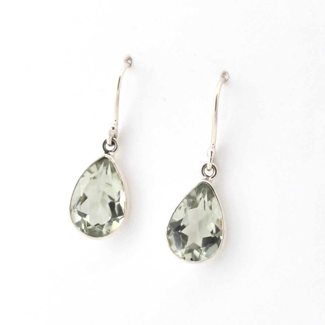 Teardrop-shaped green gemstone earrings on a white background