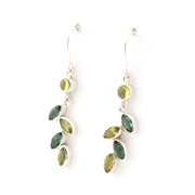 Pair of earrings with green gemstones on a white background