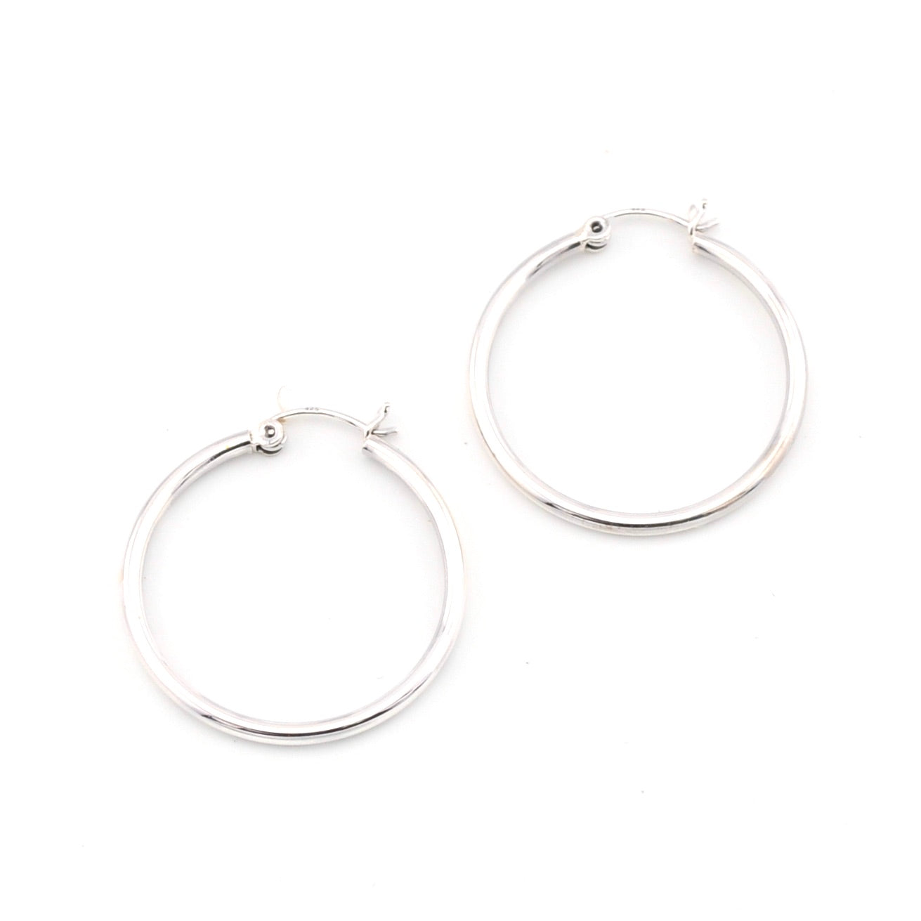 Silver hoop earrings on a white background