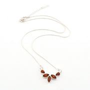 Silver necklace with brown pendant on a white background