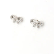 Silver bow-shaped earrings on a white background