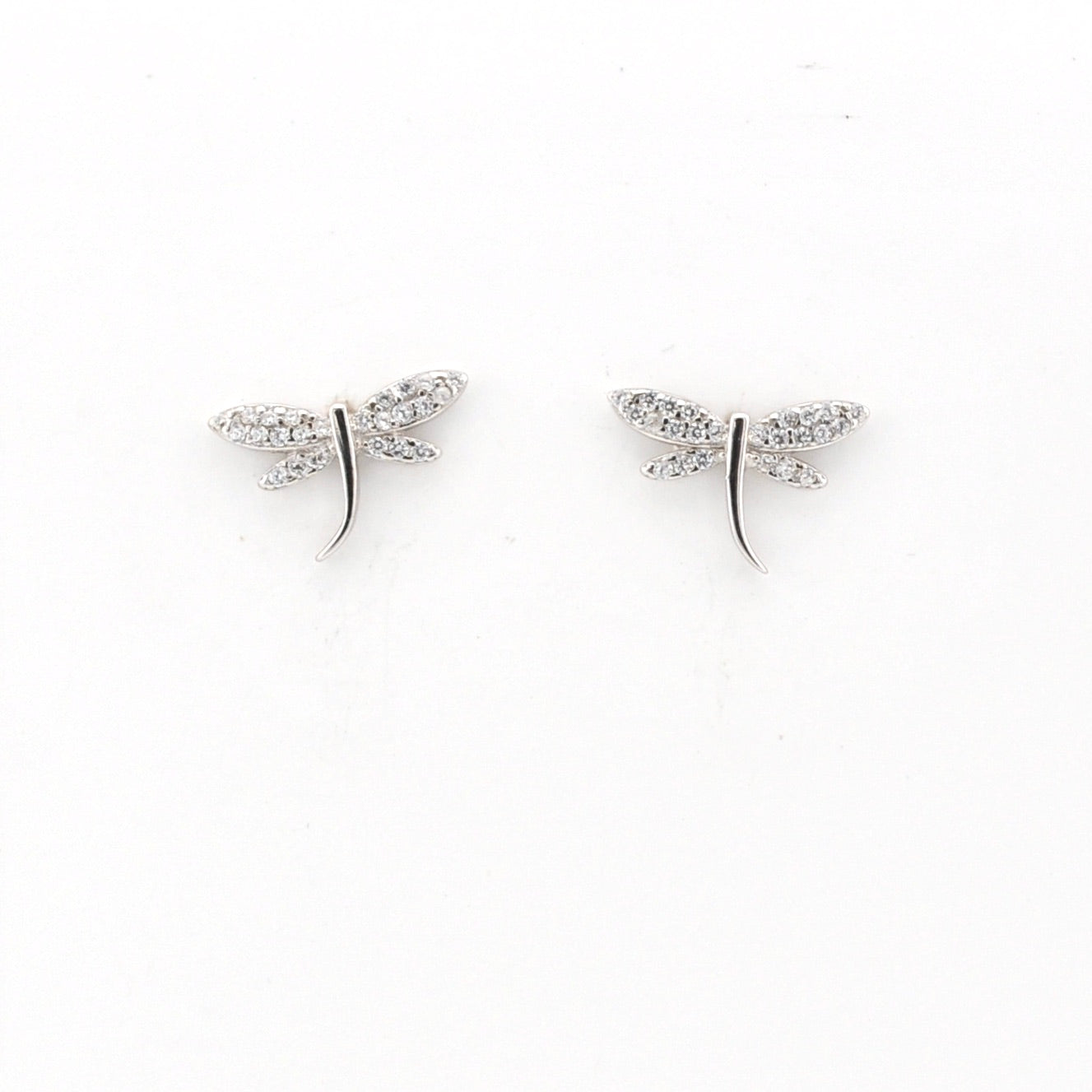 Pair of silver dragonfly earrings on a white background