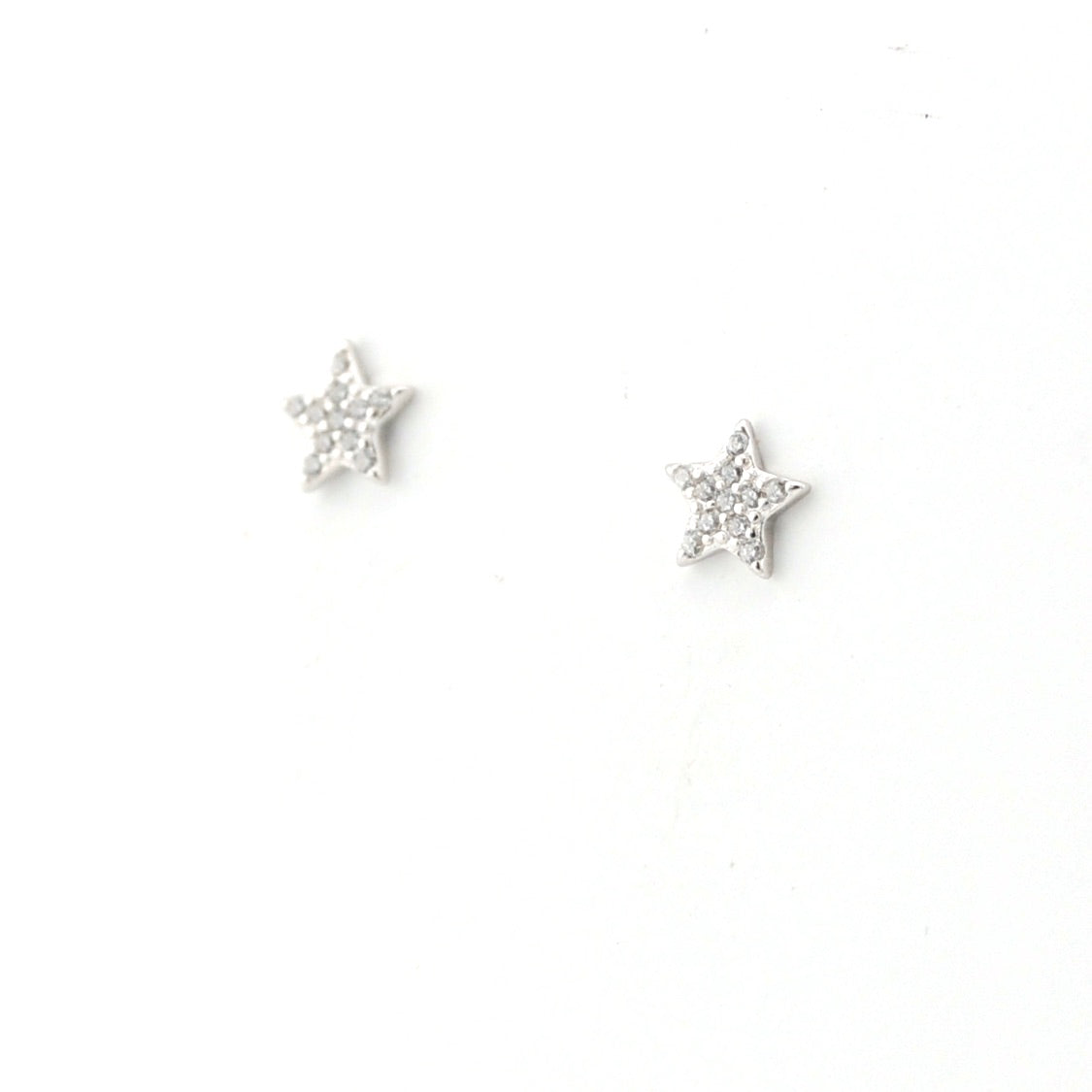 Star-shaped silver earrings on a white background