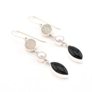 Earrings with black, white, and gold stones on a white background