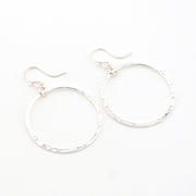 Silver hoop earrings on a white background