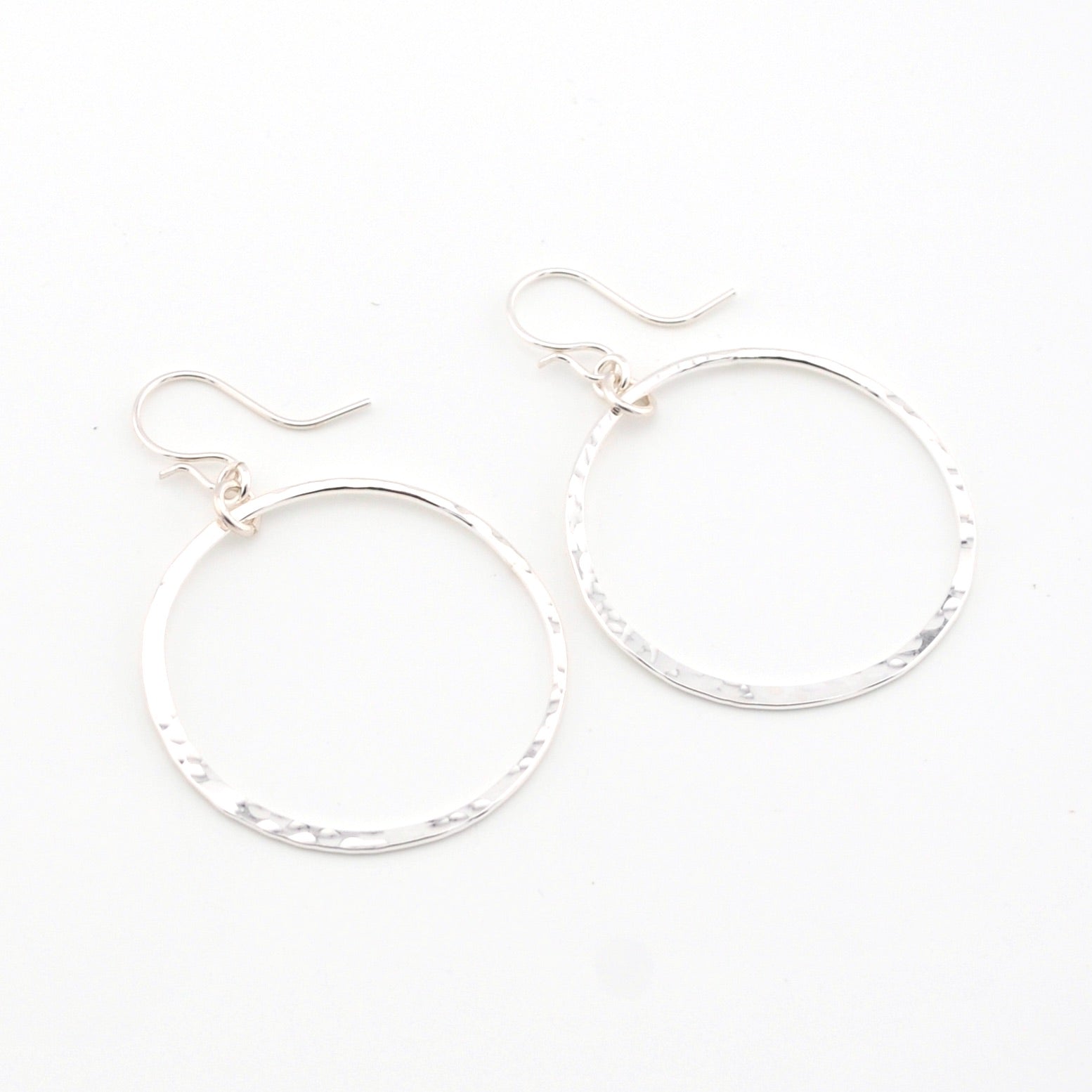Silver hoop earrings on a white background