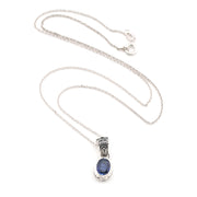 Silver necklace with a blue kyanite pendant on a white background
