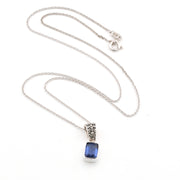 Silver necklace with a blue kyanite pendant on a white background