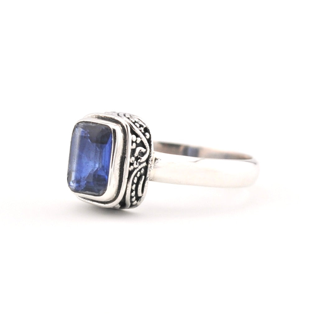 Silver ring with a blue kyanite gemstone on a white background