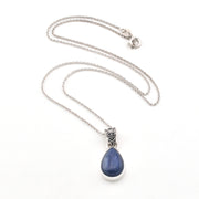 Necklace with a blue kyanite teardrop pendant on a white background